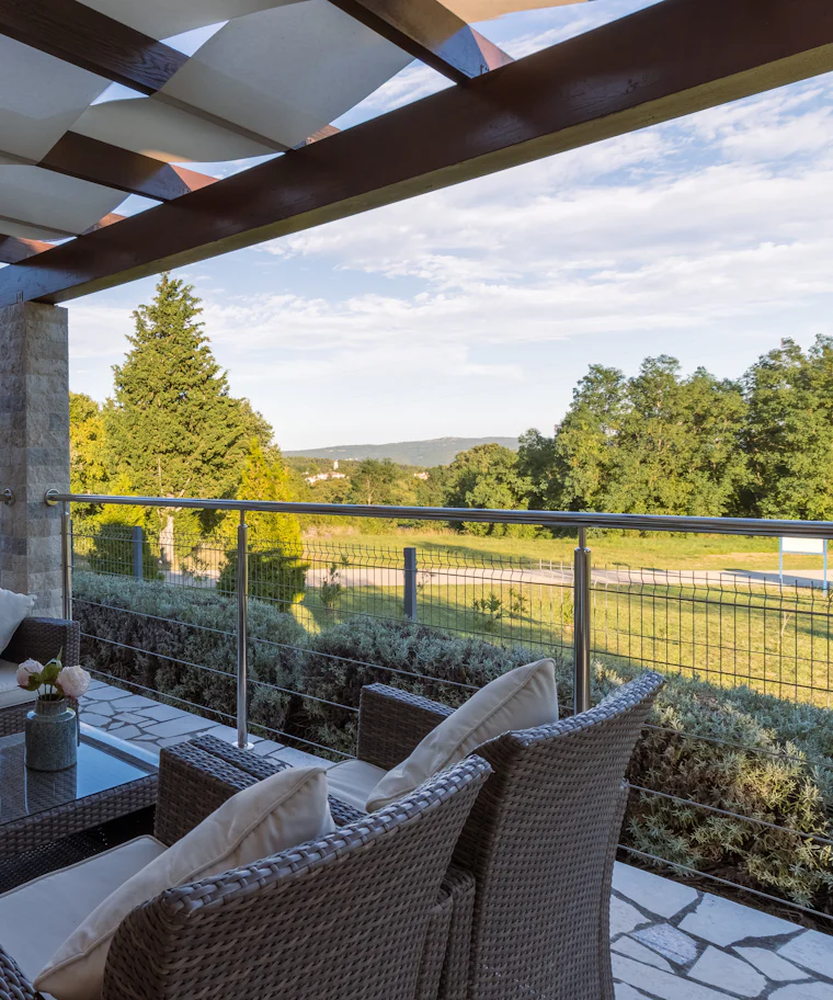 Garden terrace with wicker seating surrounded by planting
